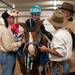 Jansen Sweeny, 6 of Belleville, pets Miko the horse surrounded by volunteers (left) Dan Lautenbach, Ypsilanti, Matthew Pickus, Saline, and Rob Martens, Ann Arbor at the Harold and Kay Peplau Therapeutic Riding Center's Halloween Trick-or-Treat horse ride. (Tanya Moutzalias for AnnArbor.com)